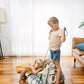 Play_pouch_Large_Dino_Roar__kids_tidying_up_by_pulling_shut_the_drawstrings