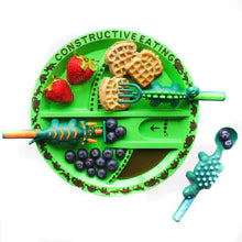 Dinosaur_plate_green_with_food_and_cutlery_on_it