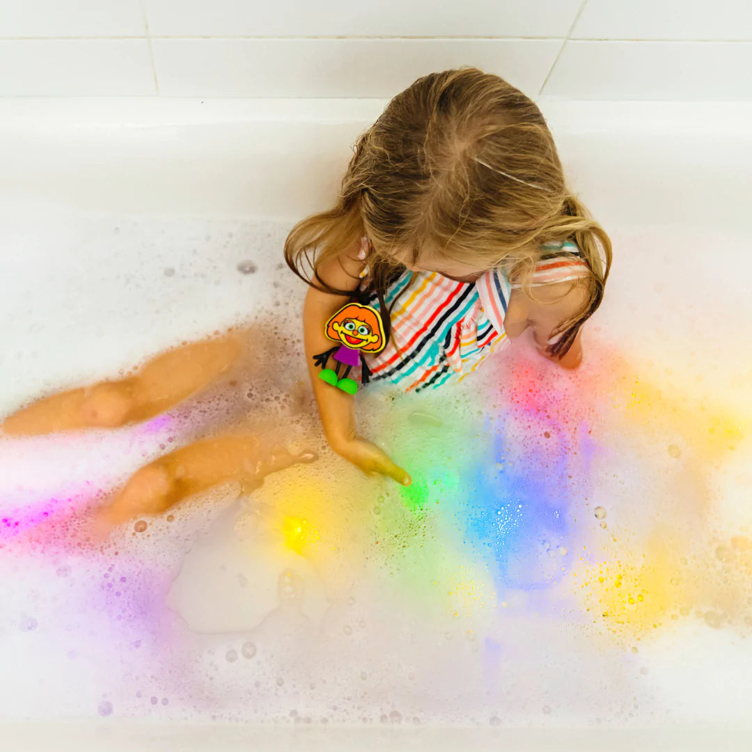 Girl_in_bathers_in_bath_playing_with_glo_pal_cube_characters