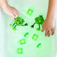 Jelly_stone_Hands_playing_with_Glo_cubes_and_characters_green_in_sensory_tub