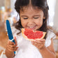 Kiddikutter_girl_cutting_grapefruit_with_KiddiKutter_knife