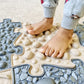 Muffik_Sensory_play_mat_natural_set_cloae_up_of_mats_with_child_standing_on_them