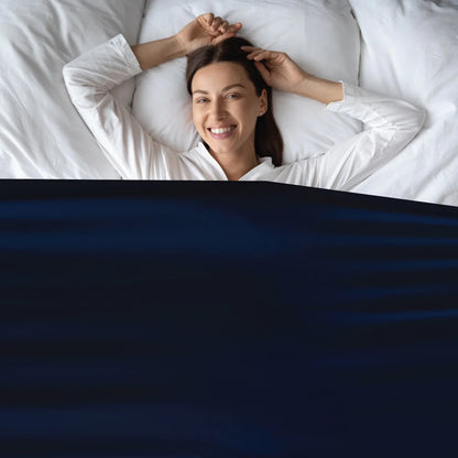 Lady_tucked_in_to_Calmcare_Sensory_Compression_Bed_Sheet_navy