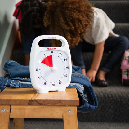 Time_Timer_Plus_visual_Timer_White_timer_set_to_10_munites_child_putting_shoes_on