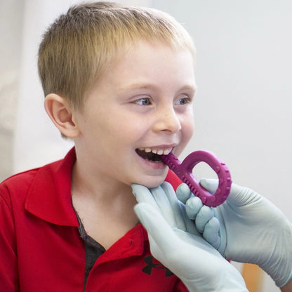 Boy_using_Arks_textured_grabber_Sensory_chew_in_Speech_therapy_session_
