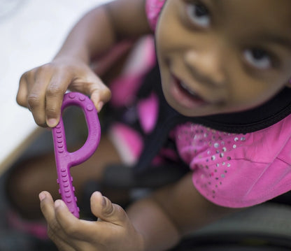 Girl_playing_with_Arks_textured_grabber_Sensory_chew