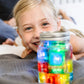 Girk_playing_with_jar_full_of_brightly_coloured_glo_pal_cubes