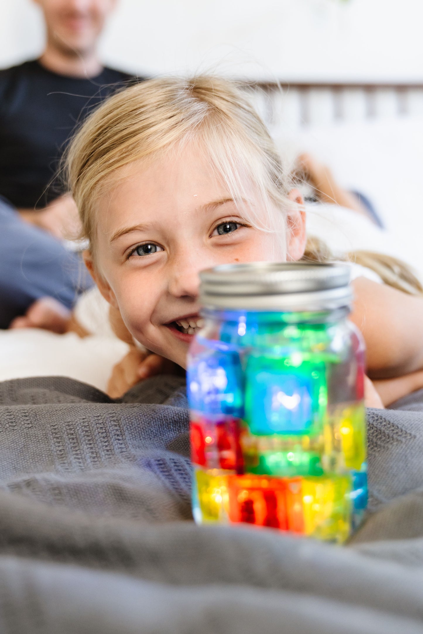 Girl_playing_with_Glo-pal_cubes_glowing_in_jar