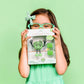 Glo-pal_Character_Pippa_Green_in_packagin_held_by_girl_in_matching_green_glasses